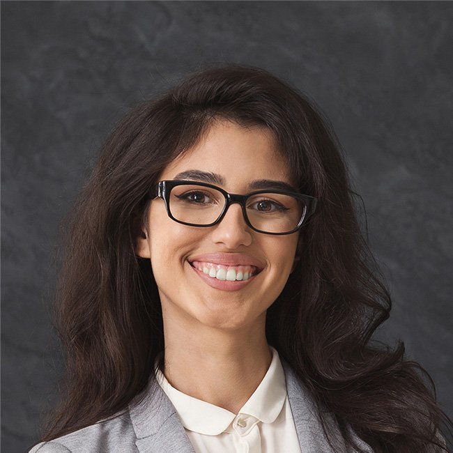 Professional businesswoman with glasses smiling in office portrait