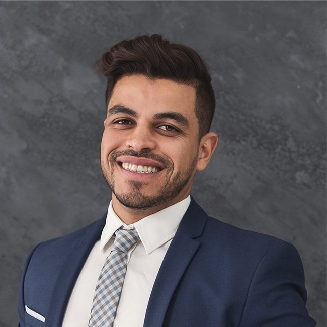 Young business professional smiling in corporate headshot portrait