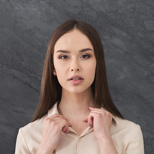 Young woman professional portrait with neutral expression and background