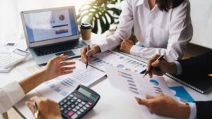 Team analyzing financial charts and graphs together during a business meeting
